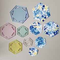 paper flowers and hexagons are arranged on a table top, including one in blue, the other in yellow