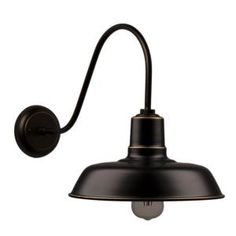 an antique style wall light with a black shade on the side and a white background