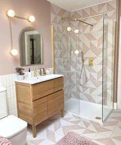 a bathroom with pink walls and white tile flooring, including a vanity sink and toilet