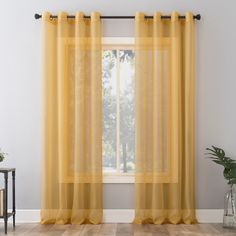 The light and airy No. 918 Emily Voile Sheer Grommet Curtain Panel gently captures light and brings modern elegance to the windows of any living space. Equipped with built-in silver metal grommets for easy hanging on curtain rods up to 1-1/2" in diameter, No. 918 Emily Voile Sheer Grommet Curtain Panel can be used alone or as an added layering piece for added privacy or a more lush look. Sold as individual panels measuring 59" width by 84" length in color curry yellow. Measure carefully before selecting your desired size and quantity. Rod not included. Machine wash cold on gentle cycle. Use non-chlorine bleach when needed. Tumble dry on low heat, using a cool iron as needed. No. 918 84-in Curry Yellow Sheer Grommet Single Curtain Panel | 58778 Yellow Gold Curtains, Curry Yellow, Yellow Curtains, Grommet Panels, Gold Curtains, Sheer Curtain Panels, Colorful Curtains, Sheer Curtain, Grommet Curtains