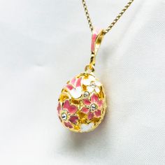 "Light and delicate reticulated egg-shaped pendant, enameled and gold plated over solid sterling silver, created in our NJ shop in the tradition and spirit of Faberge jewelry. The back and front of the egg are identical, with pink and white flowers; clear crystals are set in the center of the two larger flowers on both sides. The pendant is about 0.8 ( 19 mm ) not including  the bail . It comes with 18\" sterling silver gold plated chain and in a gift box. If you feel that you need a longer chai Faberge Jewelry, Victorian Pendants, Pink And White Flowers, Dress Indian, Clear Crystals, Gold Plated Chains, White Enamel, Style Jewelry, Flower Necklace