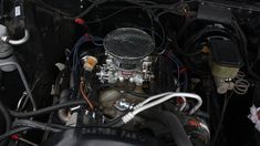 an engine is shown in this image with wires attached to the car's hood