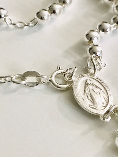 "MIRACULOUS VIRGEN 925 STERLING SILVER ITALIAN ROSARY 20\" LONG . FOR PROTECTION AND GOOD LUCK , WEDDING, COMMUNION. MADE IN ITALY 5 MM BEADS GR: 23 gr ROSARIO DE PLATA ESTERLINA DE LA VIRGEN DE LA MILAGROSA 925 SILVER, 20\" LARGO . PARA PROTECCION Y BUENA SUERTE . HECHO EN ITALIA 5 MM BEADS GR: 23 gr" Silver Necklace With Miraculous Medal For Jewelry Making, Silver Miraculous Medal Necklace With Round Beads, Silver Sterling Rosary Bracelet With Round Beads, Spiritual Silver Rosary Bracelet With Charms, Spiritual Silver Rosary Bracelet With Miraculous Medal, Spiritual Sterling Silver Rosary Bracelet, Silver Spiritual Rosary Bracelet, Silver Jewelry With Miraculous Medal And Round Beads, Silver Rosary With Miraculous Medal And Round Beads