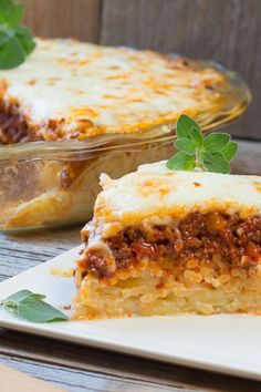 a slice of lasagna casserole on a plate with a serving utensil