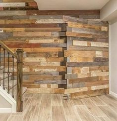 an empty room with wood planks on the wall and stairs in front of it