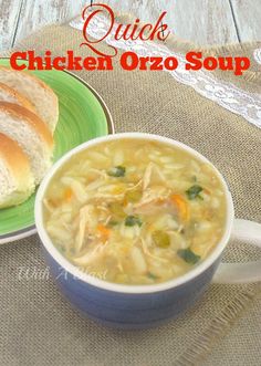 a bowl of chicken orzo soup next to a plate with bread