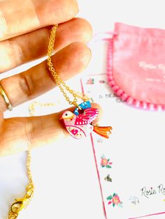 Beautiful little illustrated bird necklace Necklace Basics * Pretty little dainty bird necklace charm. * Laser cut with hard resin to give a glass affect, finished with pretty gems. * Original illustration by Rosie Parker... bring the illustration of this beautiful lady to life. * Dainty gold filled chain. * 18 inch cm drop drop length, fits perfectly on your chest. Why buy me? * I'm very lightweight - you hardly know I'm there! * Beautiful gift idea. * I'm a show stopper statement earrings. * I Bohemian Heart Pendant Charm Necklace Gift, Whimsical Heart Charm Jewelry Gift, Whimsical Heart Charm Jewelry For Gift, Handmade Cute Charm Necklaces For Mother's Day, Pink Bohemian Charm Necklace Gift, Handmade Bird-shaped Necklace For Gift, Whimsical Heart Pendant Necklace As A Gift, Whimsical Heart Pendant Necklace For Gift, Whimsical Heart Pendant Necklace Gift