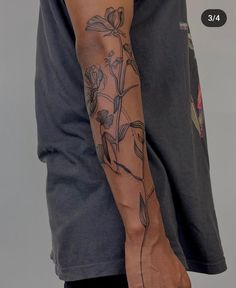 a man with a flower tattoo on his arm