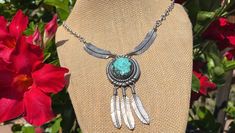 This beautiful turquoise and sterling feather necklace is in good vintage condition.  The turquoise is in good condition free of chips and cracks and is well set.  The necklace is secured with a circle spring clasp in good working condition.  The necklace hasn't been polished and has a nice even patina.  End to end the necklace measures 22 inches.  At the center it measures 2 3/4 inches from the top of the turquoise pendant to the tip of the feathers.  The three feathers are all free swinging.  It weighs 33 grams and is hallmarked E B, Sterling and the E is larger than the B.  I don't know who made this necklace. Adjustable Turquoise Jewelry With Feathers, Turquoise Feather Jewelry As Gift, Turquoise Feather Jewelry As A Gift, Bohemian Turquoise Jewelry With Feathers, Turquoise Bohemian Jewelry With Feathers, Dangle Necklace, Feather Necklace, Native American Turquoise, American Turquoise