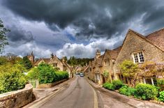 an empty street lined with stone houses under a cloudy sky in the cot cots