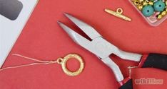 a pair of scissors and some beads on a table