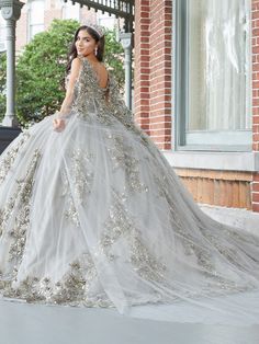 You'll love twirling around in this 3D floral applique long off the shoulder cape dress with A-line skirt by House of Wu 26052. Off-the-shoulder neckline with sequin lace appliqués and sparkle tulle ball gown skirt. Has a lace-up back and train. The detachable cape is included - giving you a versatile second look! House of Wu Quinceanera Collection Spring 2023 Style Number: 26052 Fabric: Tulle/Sequin Lace Appliques/3D Floral Appliques Please note: There may be a loss of glitter while wearing thi Floral Quinceanera Dress, Floral Cape, Quinceanera Collection, Mary's Bridal, Tulle Balls, Quinceanera Dress, Ball Gown Skirt, Tulle Ball Gown, Cape Dress