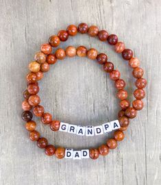 Dad Bracelet - the gift he never knew he needed  Made with wooden beads or 3mm seed beads. Wooden beads are positive intentions beads and have lava rock energy 🌋🌋they are giving all the positive vibes 🌊 Customize bracelet with personalized word or saying and bead colors. See color chart in photos. We have circle and square letters.  CARING TIPS FOR YOUR JEWELRY ⭐️Treat and store with care. ⭐️ For longevity, avoid exposing your jewelry to water. ⭐️ Avoid having direct contact with lotions, perfumes, sanitizers as these chemicals may cause discoloration of your jewelry. Personalized Bracelets For Father's Day, Name Bracelets For Father's Day Gift, Father's Day Gift Jewelry With Letter Beads, Brown Stretch Bracelet With Letter Beads As Gift, Personalized Brown Bracelet For Father's Day, Brown Bracelets For Father's Day Personalized Gift, Customize Bracelet, Square Letters, Dad Bracelet