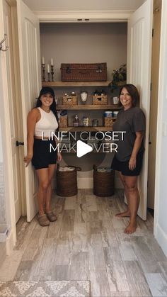 two women standing next to each other in front of an open closet with baskets on the floor