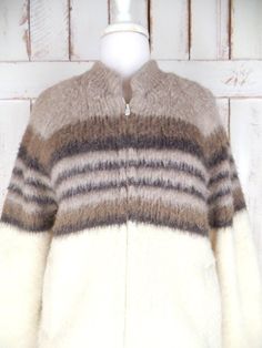 "Vintage Tundra ivory/brown striped thick virgin wool knit chunky cardigan sweater/snow/ski cabin sweater jacket/Scandinavian yarn Measurements... taken flat -marked size: medium -chest: 22\"  -length: 26\"  -sleeve: 29\" ...from neckline Features... -thick cozy 100% pure virgin wool/Scandinavian yarn  -awesome texture and feel -great neutral colors -zipper closure -side pockets/stretch cuffs -fully lined  -Tundra Fleece -made in Canada  Condition... -great vintage condition -small faint minor d Cozy Striped Winter Outerwear, Brown Hand Knitted Winter Outerwear, Cream Fair Isle Pattern Outerwear For Fall, Cozy Brown Outerwear With Fair Isle Pattern, Cream Fair Isle Outerwear For Fall, Scandinavian Style Knitted Outerwear For Fall, Winter Striped Wool Outerwear, Striped Knitted Winter Outerwear, Vintage Striped Winter Outerwear