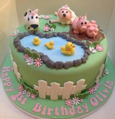 a birthday cake decorated with farm animals and ducks