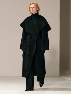 This luxurious 100% wool coat combines timeless elegance with practical warmth, featuring a versatile drape design and generous shawl collar that can be styled multiple ways with the detachable belt. The relaxed silhouette offers a comfortable, blanket-like embrace while maintaining a sophisticated profile perfect for any season. Handcrafted with meticulous attention to detail, this coat includes functional elements like side welt pockets, a back center vent, and full twill lining, making it bot Oversized Black Wool Coat, Row Aesthetic, Hijabi Modest Outfits, Oversized Overcoat, Wool Kimono, Opera Coat, Christmas Board, Kimono Coat, Wool Tie