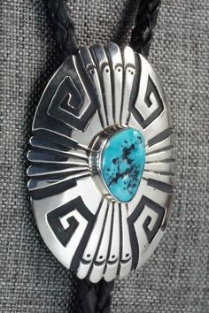 This turquoise and sterling silver bolo tie was made by Navajo silversmith Rosita Singer. The back is signed T&R Singer and stamped sterling.Tie Length: 22"Length: 2 3/8"Width: 1 3/4"Tips:Length: 2 1/8"Width: 1/4"Free shipping on all orders! We ship with USPS and always include tracking. All orders ship within a day of payment.Returns are accepted up to 30 days after you receive your order. Just send us a message. Our shop offers cash back or store credit. The item must be returned in new condit Adjustable Southwestern Silver Turquoise Necklace, Southwestern Sterling Silver Bolo Tie As Gift, Artisan Silver Bolo Tie With Concho, Western Silver Turquoise Necklace With Concho, Artisan Turquoise Bolo Ties With Concho, Handmade Southwestern Silver Bolo Ties, Southwestern Adjustable Turquoise Bolo Ties, Southwestern Style Sterling Silver Bolo Tie, Luxury Southwestern Sterling Silver Bolo Tie