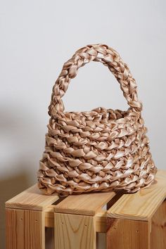 a woven basket sitting on top of wooden blocks