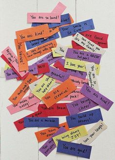 several pieces of colored paper with words written on them