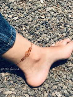 a woman's foot with a small tattoo on it