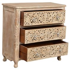 an ornate wooden drawer with three drawers