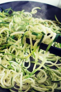 some noodles are being cooked in a wok