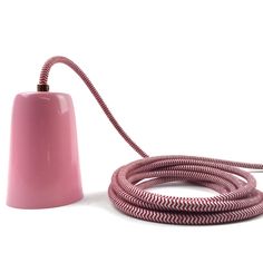 a pink lamp is plugged into a cord