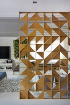 a living room filled with furniture and a large mirror on top of a wooden shelf