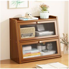 a wooden cabinet with two glass doors on the top and bottom, filled with books