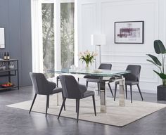 a glass dining table with grey chairs and a white rug in front of the window