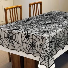 a spider web tablecloth on a dining room table