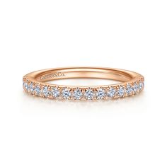 an 18k rose gold wedding band with round brilliant cut diamonds on the side, set in