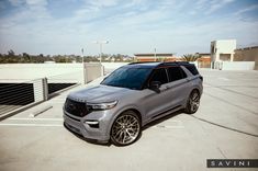 a silver suv parked in a parking lot