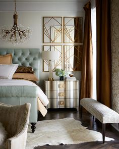 a bedroom decorated in gold and white with an upholstered bed