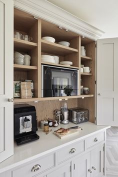 a kitchen with white cabinets and open shelves