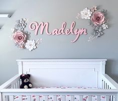 there is a baby crib with flowers on the wall