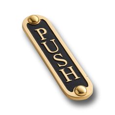 a black and gold push sign with the word push on it's front end