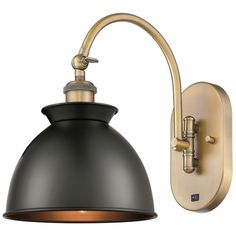 a black and gold wall light on a white background