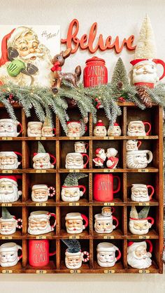 a wooden shelf filled with santa mugs and christmas decorations