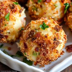 some appetizers are sitting on a plate with parmesan cheese and herbs