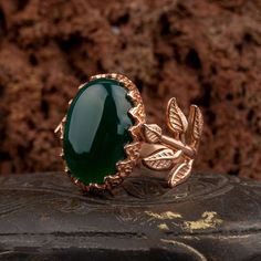 Green Aqeeq Flower Rose Gold Plated Silver Women Ring. Handmade in 925 gold color plating sterling silver with agate stone. On the ring Oval Green Aqeeq - Agate stone settled. At sides, flower figure settled with micro detailed ornament. Dimensions of stone is 20 mm x 15 mm. Average weight of Green Aqeeq Flower Rose Gold Plated Silver Women Ring is 9 gr. (depends on your ring size). Back side is open and stone touches your skin. Classic and exclusive style. Stone Type: Aqeeq - Agate Stone Color: Luxury Jade Jewelry For Anniversary, Luxury Agate Wedding Jewelry, Elegant Agate Jewelry For Anniversary, Nature-inspired Gold Jade Jewelry, Jade Jewelry With Polished Finish For Anniversary, Elegant Chalcedony Jewelry For Anniversary, Anniversary Jewelry In Polished Jade, Luxury Jade Ring Jewelry, Anniversary Jade Jewelry With Polished Finish