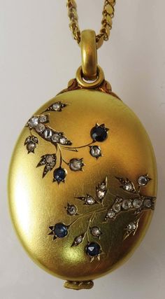 For Sale on 1stdibs - Beautiful Vintage 18K yellow gold oval locket, with floral motif, set with 31 rose cut diamonds and 4 rose cut blue sapphires, monogram engraved on back Antique Gold Locket, Oval Locket, Gold Locket, Fabulous Jewelry, Rose Cut Diamond, Rose Cut, Floral Motif, Antique Gold, Locket