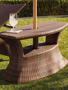 a table with an umbrella on it in the grass