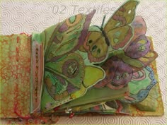 an open book with butterflies on it