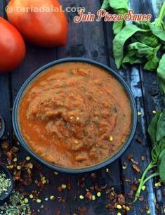 there is a bowl of tomato sauce next to some tomatoes