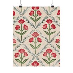 a red and green flower pattern on a white background with two hooks hanging from the wall