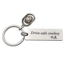 a metal keychain with the words drive safe cowboy on it's side