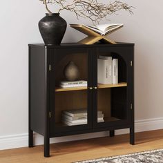 a book shelf with books and a vase on top