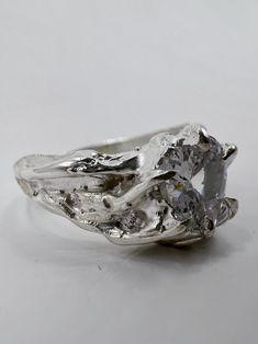 a close up of a silver ring on a white surface